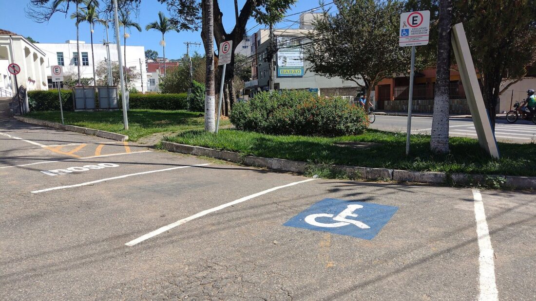 Vaga de estacionamento reservada a pessoas com deficiência, com o símbolo de acessibilidade pintado no asfalto